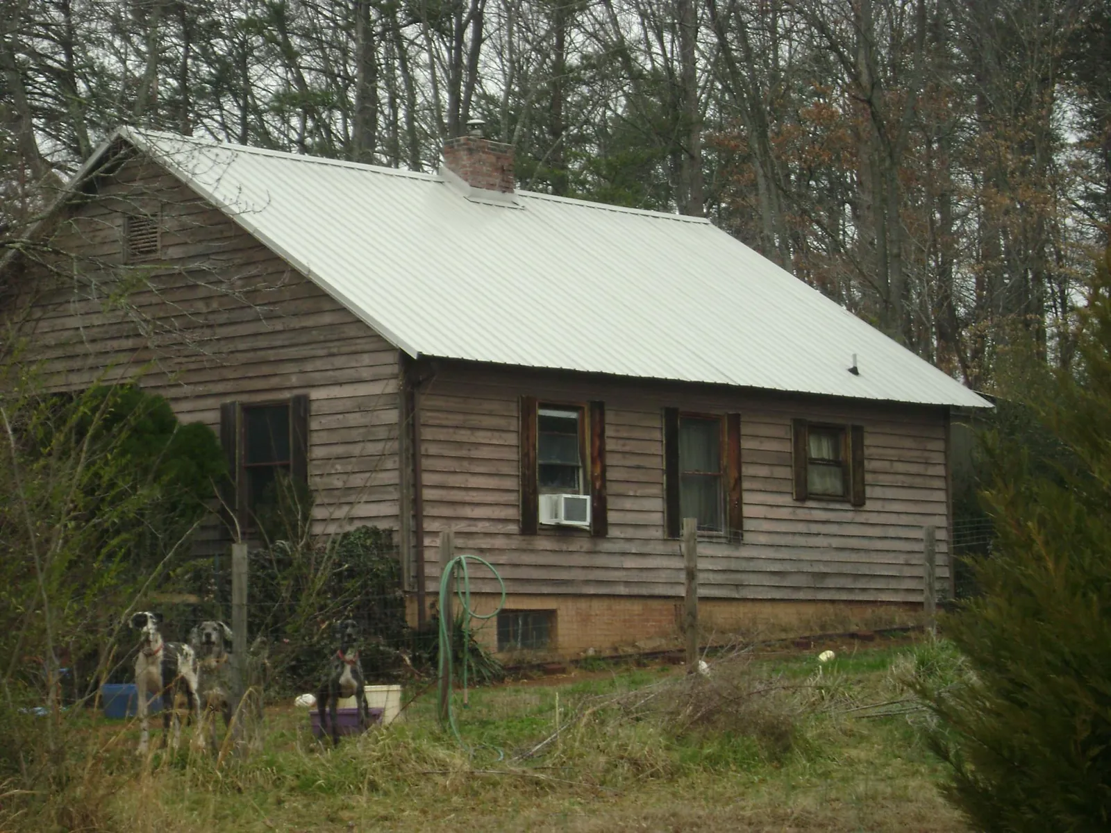 White metal roof on an old wood sided farmhouse, from a Metal Roof Installation job in New Hartford